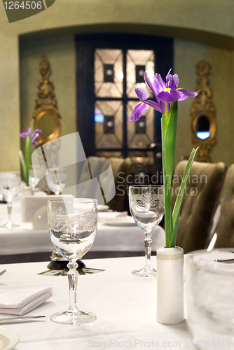 Image of served table in restaurant with flower