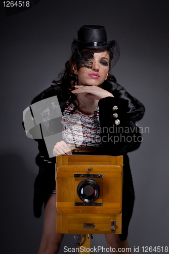Image of Old-style portrait of lady with vintage camera