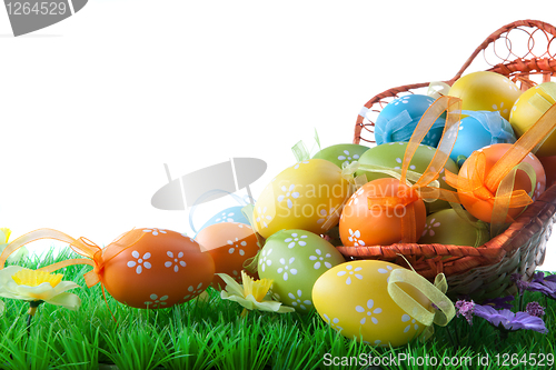 Image of color easter eggs in basket isolated on white