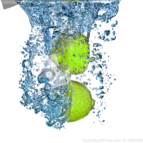 Image of Fresh lime dropped into water with bubbles isolated on white