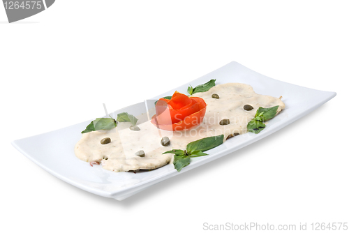 Image of slices of ham with sauce on the plate isolated on white