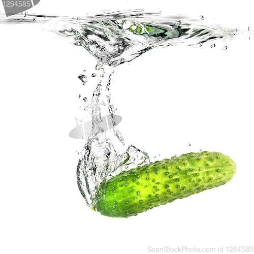 Image of green cucumber dropped into water isolated on white