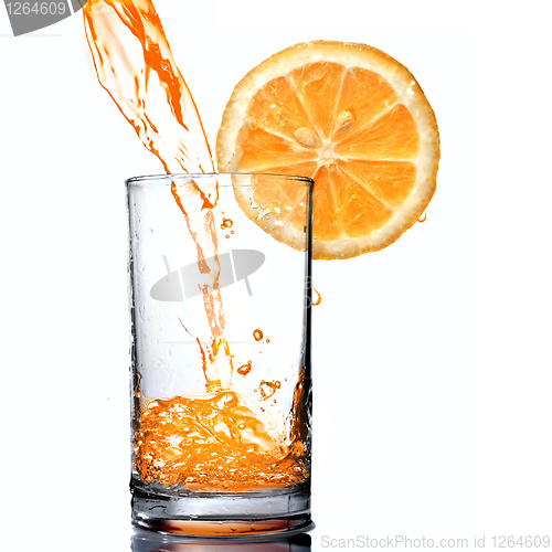 Image of orange juice pouring into goblet with orange slice