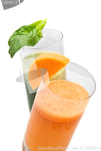 Image of fresh juices from carrot and parsley in glasses isolated on white