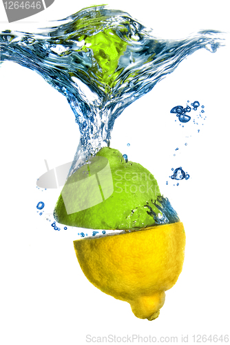 Image of lemon and lime dropped into water with bubbles isolated on white