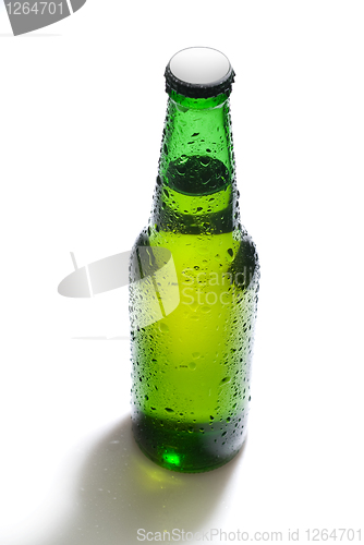 Image of Green beer bottle with water drops isolated on white
