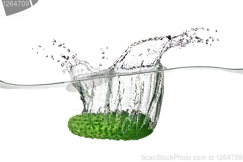 Image of green cucumber dropped into water isolated on white