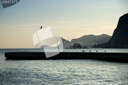 Image of landscape with sea and mountains on sunset