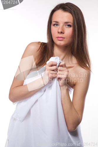 Image of Attractive woman covered in white cloth on white