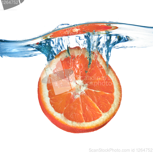 Image of Fresh grapefruit dropped into water with splash isolated on whit