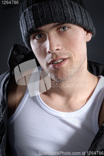 Image of fashion portrait of young smiling man in hat