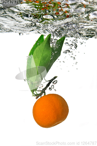 Image of tangerine dropped into water with bubbles on white