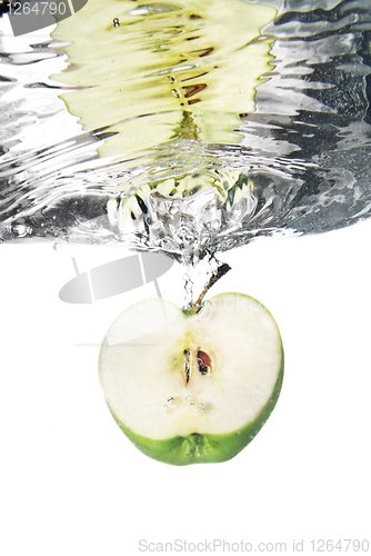 Image of green apple dropped into water with bubbles isolated on white