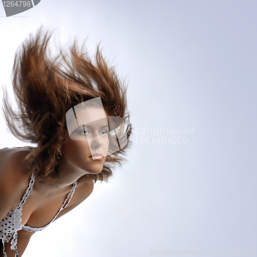 Image of young woman with hair in motion