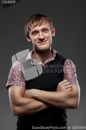 Image of Young smiling man on black