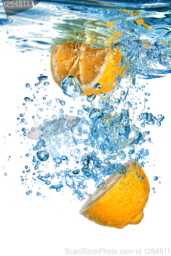 Image of Fresh orange dropped into water with bubbles isolated on white