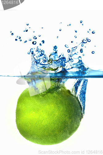 Image of Fresh lime dropped into water with bubbles isolated on white