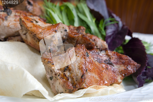 Image of fried meat with potherbs on the plate