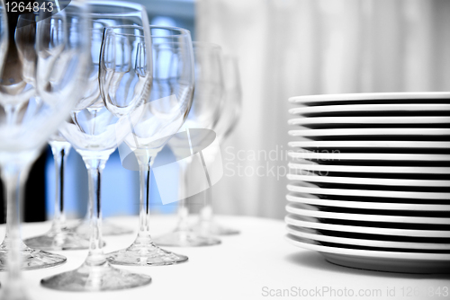 Image of glass goblets and plates on the table