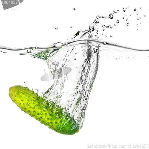 Image of green cucumber dropped into water isolated on white