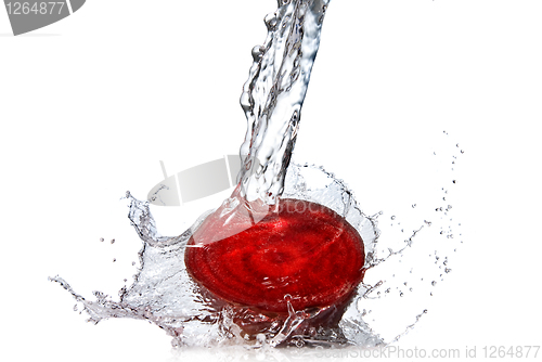 Image of red beet with water splash isolated on white