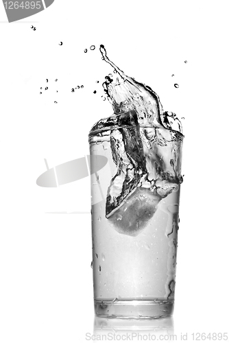 Image of water splash in glass isolated on white