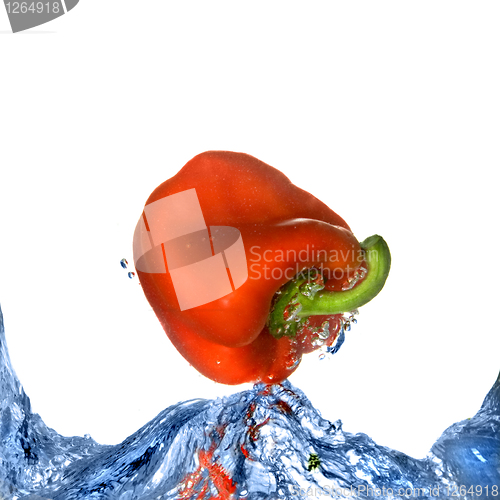 Image of Red pepper with splash of blue water isolated on white