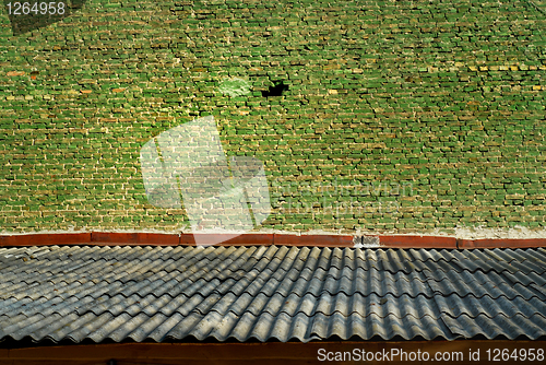 Image of Old green bricks wall and shiver roof