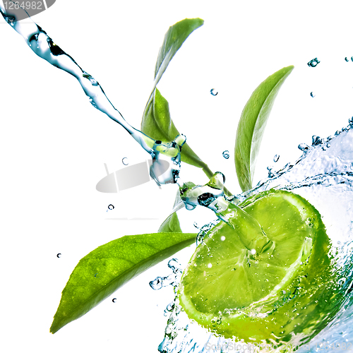 Image of water drops on lime with green leaves isolated on white