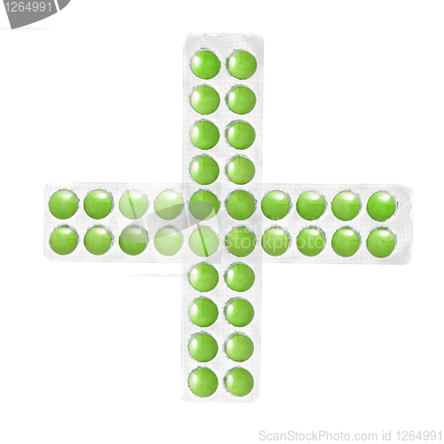 Image of cross from packs of green tablets isolated on white