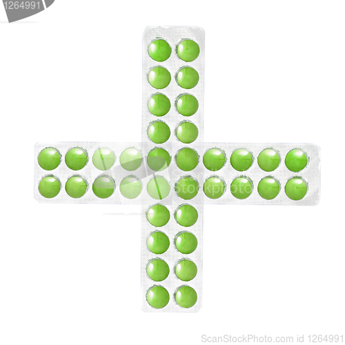 Image of cross from packs of green tablets isolated on white