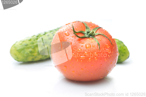 Image of red tomato and green cucumber with water drops isolated on white