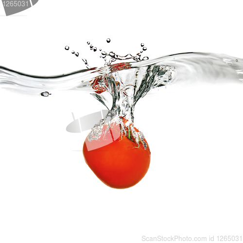 Image of red tomato dropped into water isolated on white