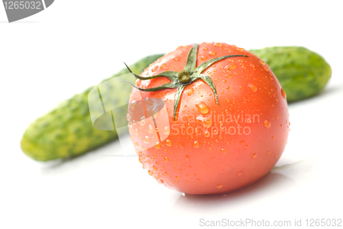 Image of red tomato and green cucumber with water drops isolated on white