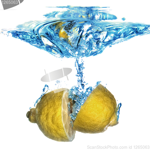 Image of lemon dropped into water with bubbles isolated on white