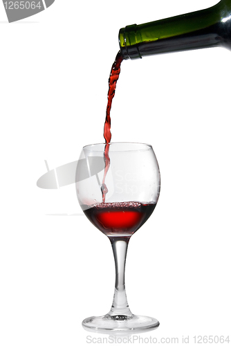 Image of Pouring red wine in glass goblet isolated on white