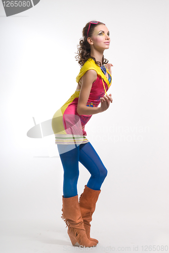 Image of Beautiful young woman posing in color wear