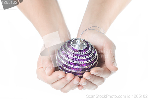 Image of hands holding christmas ball isolated on white