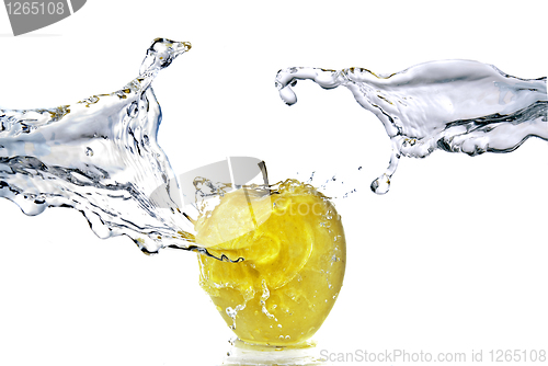 Image of perfect fresh water splash on yellow apple isolated on white