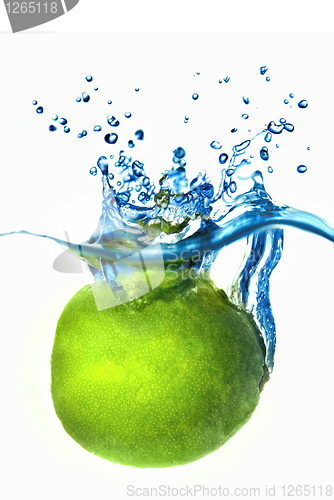 Image of Fresh lime dropped into water with bubbles isolated on white