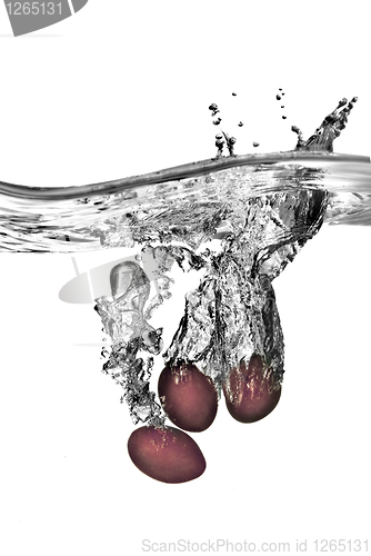 Image of plum dropped into water with bubbles isolated on white