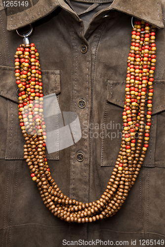 Image of brown shirt with color necklace