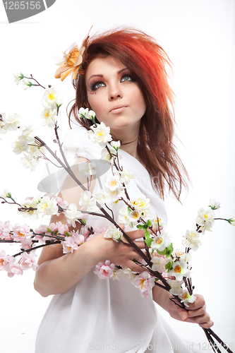 Image of Portrait of beautiful woman with spring flowers on white