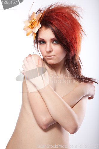 Image of Portrait of beautiful naked woman with spring flower in hair on white