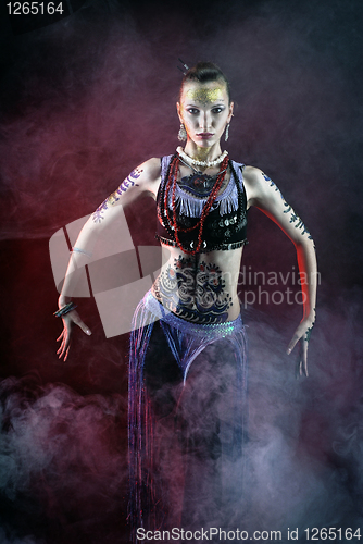 Image of tribal girl dancing in fog