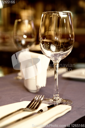 Image of wineglass on served table in restaurant