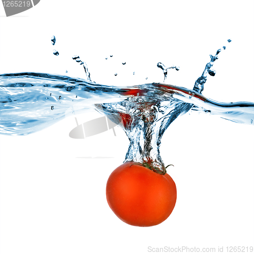 Image of red tomato dropped into water isolated on white