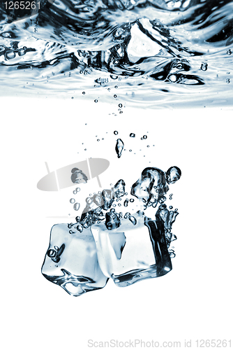 Image of ice cubes dropped into water with splash isolated on white