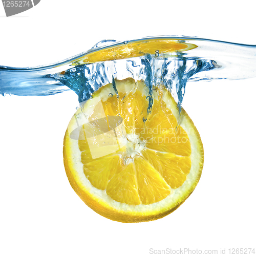 Image of Fresh lemon dropped into water with splash isolated on white