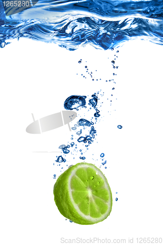 Image of Fresh lime dropped into water with bubbles isolated on white